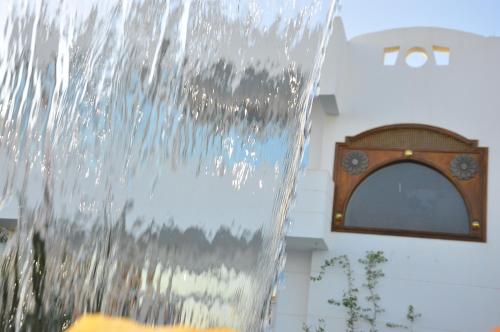 a water fountain in front of a building with a window at Villa Shahrazad Sharm El Sheikh in Sharm El Sheikh
