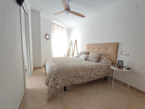 a white bedroom with a bed and a window at GUADALEST DREAMS in Guadalest