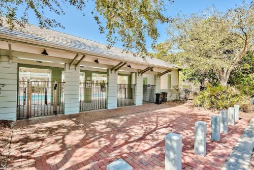 a house with a gate and a fence at Beach Bungalow, 3 Min Walk to Beach, Golf Cart, 4 bikes, Wagon in Seacrest
