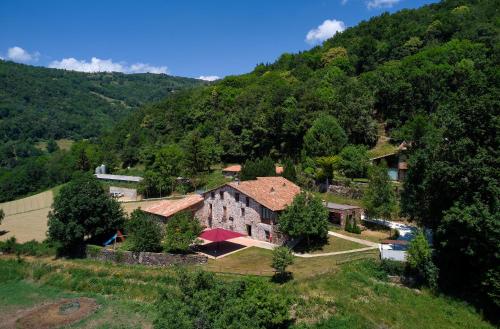 an aerial view of a house in a mountain at Casa Rural "Can Soler de Rocabruna" Camprodon in Rocabruna