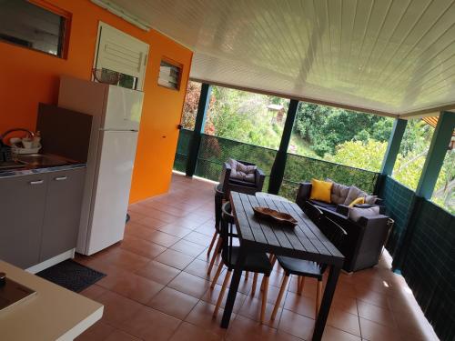 a kitchen and dining room with a table and chairs at Appartement Kelysa in Le Marin