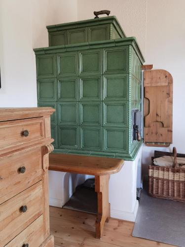 a green cabinet sitting on top of a wooden table at Kellerstöckl Kranach 76 in Gamlitz