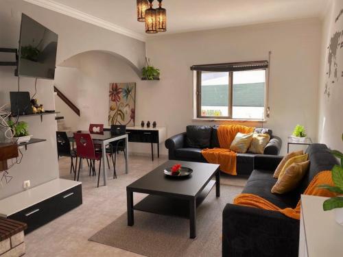 a living room with a couch and a table at Private Villa 4 BR&patio - 3 mins from Beach&Surf in Baleal