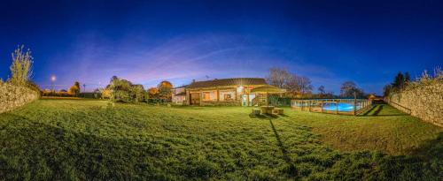 a large yard with a house and a swimming pool at Casa das xacias ribeira sacra in A Airoa