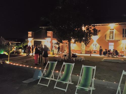 a group of green and white chairs in front of a building at Helix 1912 in Bric Gallo