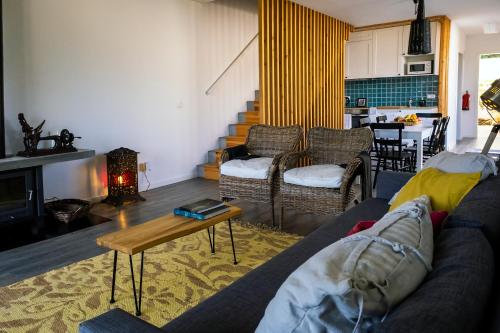 a living room with a couch and a table at FURNAS HOUSES in Furnas