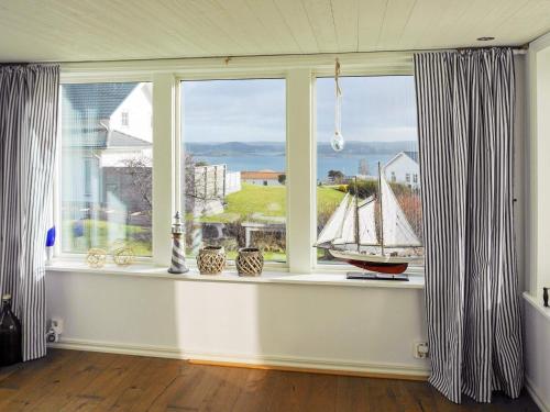 a room with a window with a sail boat in it at 6 person holiday home in Höviksnäs-By Traum in Höviksnäs