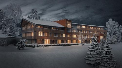 a large building in the snow at night at Zadov - Apartmán Srdce Šumavy in Stachy