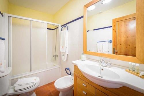 a bathroom with a sink and a toilet and a mirror at Casa das xacias ribeira sacra in A Airoa