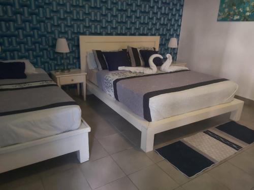 duas camas em um quarto com cisnes nelas em Punta Cana Sol Caribe Beach Pool em Punta Cana