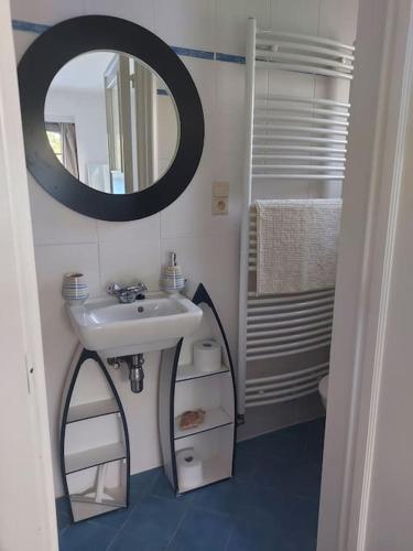 a bathroom with a sink and a mirror at Au Clos Caleste in Wellin