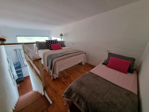 a bedroom with two beds and a balcony at Il Piccolo Borgo in Montalto di Castro