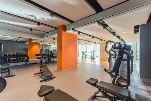 a gym with a lot of treadmills and machines at Premium 2+1 BR condo in the heart of Bluewaters Island in Dubai