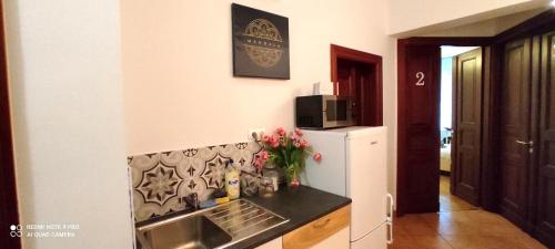 a kitchen with a sink and a refrigerator at Mandala Hostel in Poznań