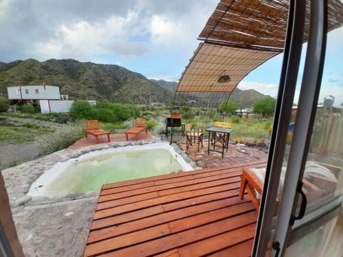 a view from a window of a patio with a pool at ECOCABAÑAS CERRO ARKO in Mendoza
