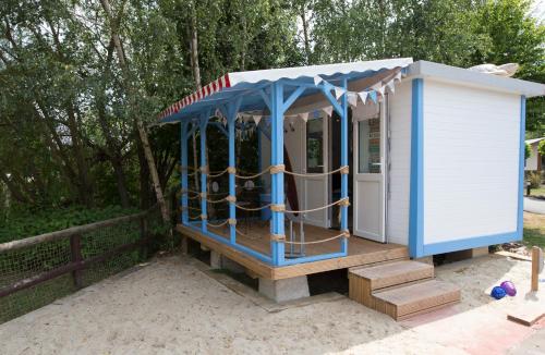 a blue and white play house with ropes in it at Adventurer's Village Milton Keynes in Milton Keynes