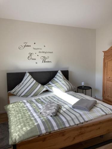 a bedroom with a bed with a sign on the wall at Apartment Panoramablick in Bad Bergzabern