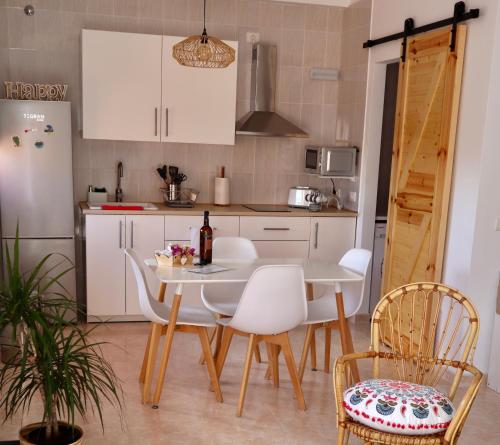 a kitchen with a table and chairs and a refrigerator at Casa Ninive in Fuencaliente de la Palma