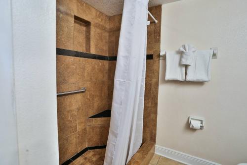 a shower with a shower curtain in a bathroom at 103 - Sandy Shores in St. Pete Beach