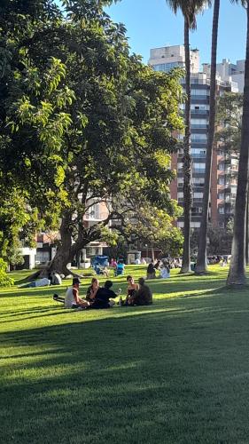 a group of people laying on the grass in a park at Mónaco in Montevideo