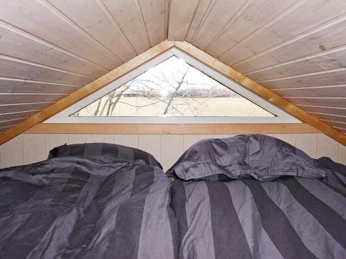 a bed in a small room with a window at 4 person holiday home in Mörbylånga-By Traum in Mörbylånga