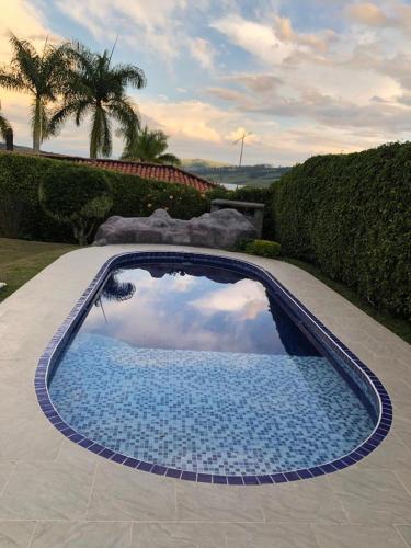 a swimming pool with a reflection of the sky at CHALET SANTORINI in Calima