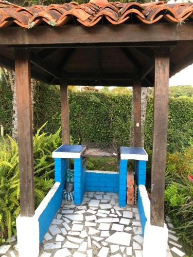 a blue bench sitting under a pavilion at CHALET SANTORINI in Calima