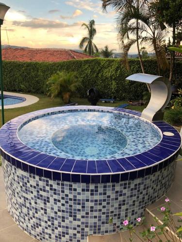 a hot tub with a blue and white tile around it at CHALET SANTORINI in Calima