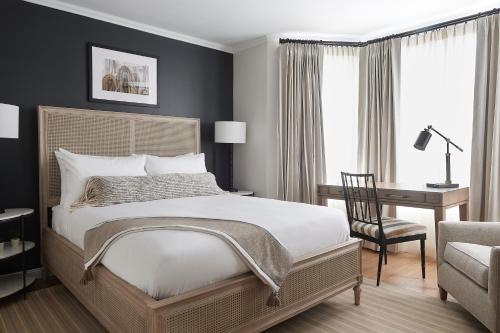 a bedroom with a bed and a desk and a chair at The Federal in Brunswick