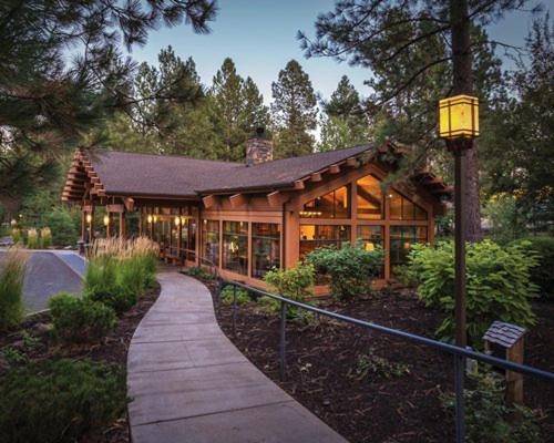 a large wooden building with a pathway in front of it at Seventh Mountain Resort in Bend