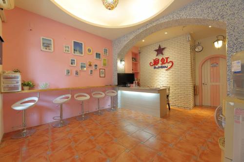 a room with stools and a bar in a restaurant at Rainbow B&B in Dahan