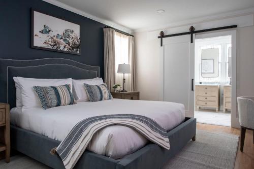 a bedroom with a large bed with a blue wall at The Federal in Brunswick