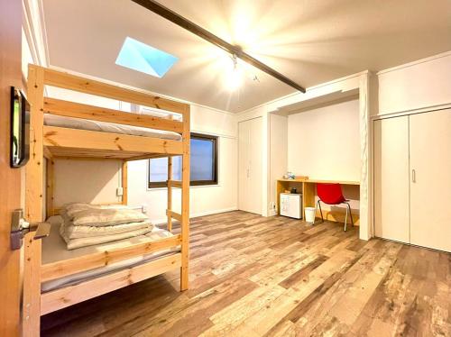 une chambre avec un lit superposé et un bureau dans l'établissement 島宿Nest, à Onomichi