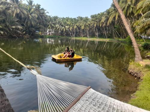 a group of people in a yellow boat on a river at Riverlap homestay in Nīleshwar