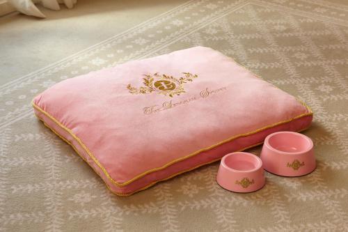 a pink napkin with two cups on the floor at The Langham Sydney in Sydney