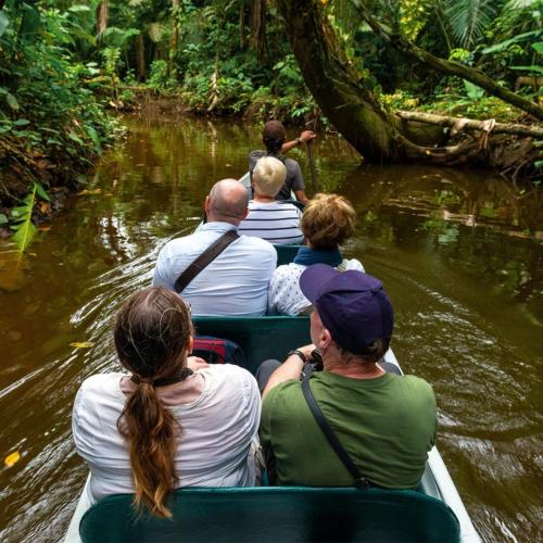 a group of people riding in a boat in the water at Ecolucerna Lodge Tambopata in Puerto Maldonado