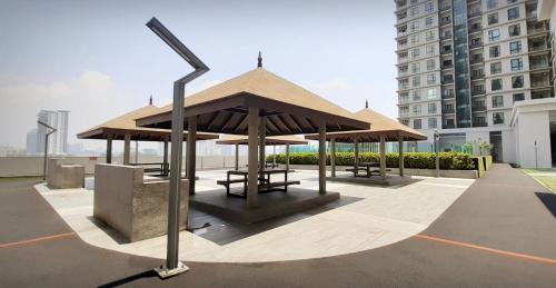 a pavilion with tables and benches on a rooftop at Sunway Paradise Home Staycation PH2120 SELF CHECK IN OUT in Subang Jaya