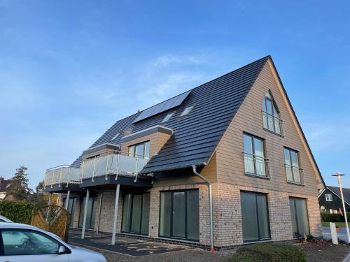 una casa con paneles solares en el techo en Lagertha - Maisonette, en Büsum