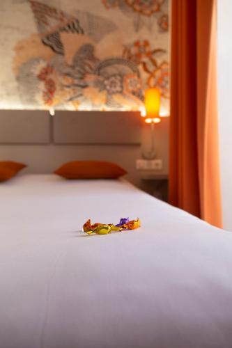 a piece of wrapper sitting on a bed at Hotel Victoria in Strasbourg