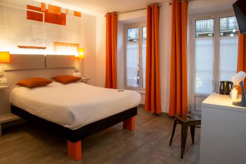 a bedroom with orange curtains and a large bed at Hotel Victoria in Strasbourg