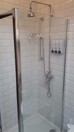 a shower with a glass door in a bathroom at The Byre North End Farm in Ashton Keynes