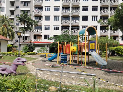a playground in front of a large building at Beach View Private Apartment in Port Dickson