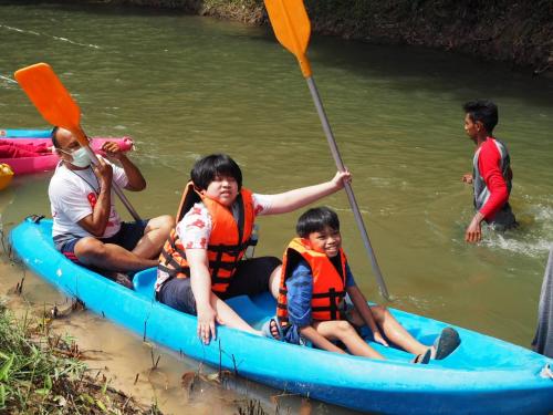 a group of people in a blue raft in the water at โฮมสเตย์บ้านนายสิงโตเขาคูหา in Ban Khu Ha Nai (1)