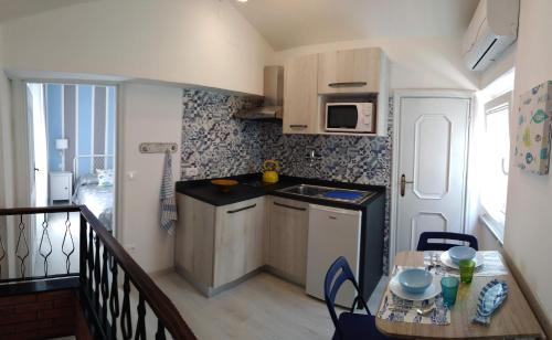 蒙泰羅索阿爾馬雷的住宿－La Casetta Rosa，一个带桌子的小厨房和一个阳台