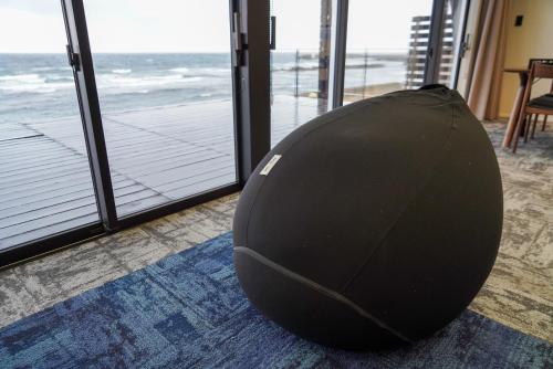 a bean bag chair sitting on a rug in front of a window at Sinori205 in Hakodate
