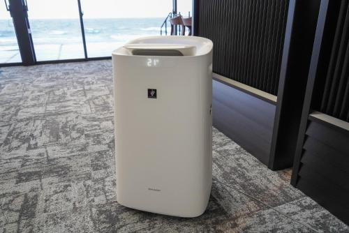 a white trash can sitting in a room with the ocean at Sinori205 in Hakodate