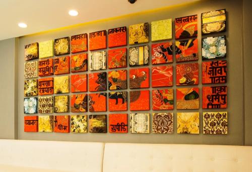 a wall of art on a wall at The Fern Residency Mumbai in Mumbai