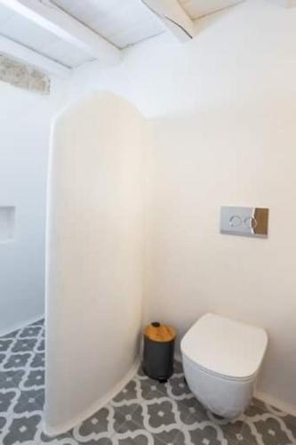 a bathroom with a white toilet in a room at Grannys Villas finiki in Karpathos Town