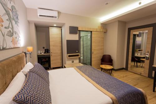 a hotel room with a bed and a television at Levor Hotel in Bursa
