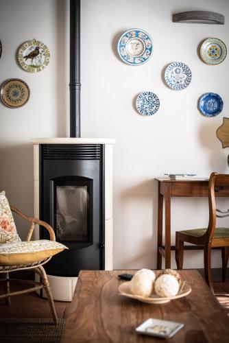 a living room with a fireplace and a table at Casa Locci in Capannori